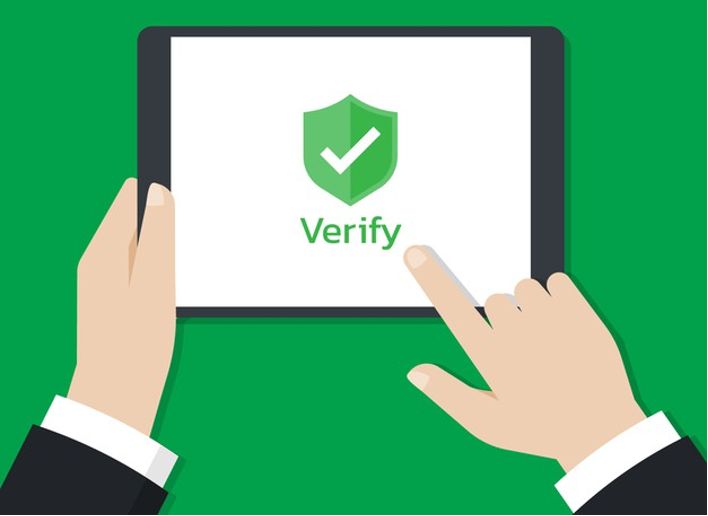 Hands holding a tablet and touch on the screen with shield icon that show on the screen